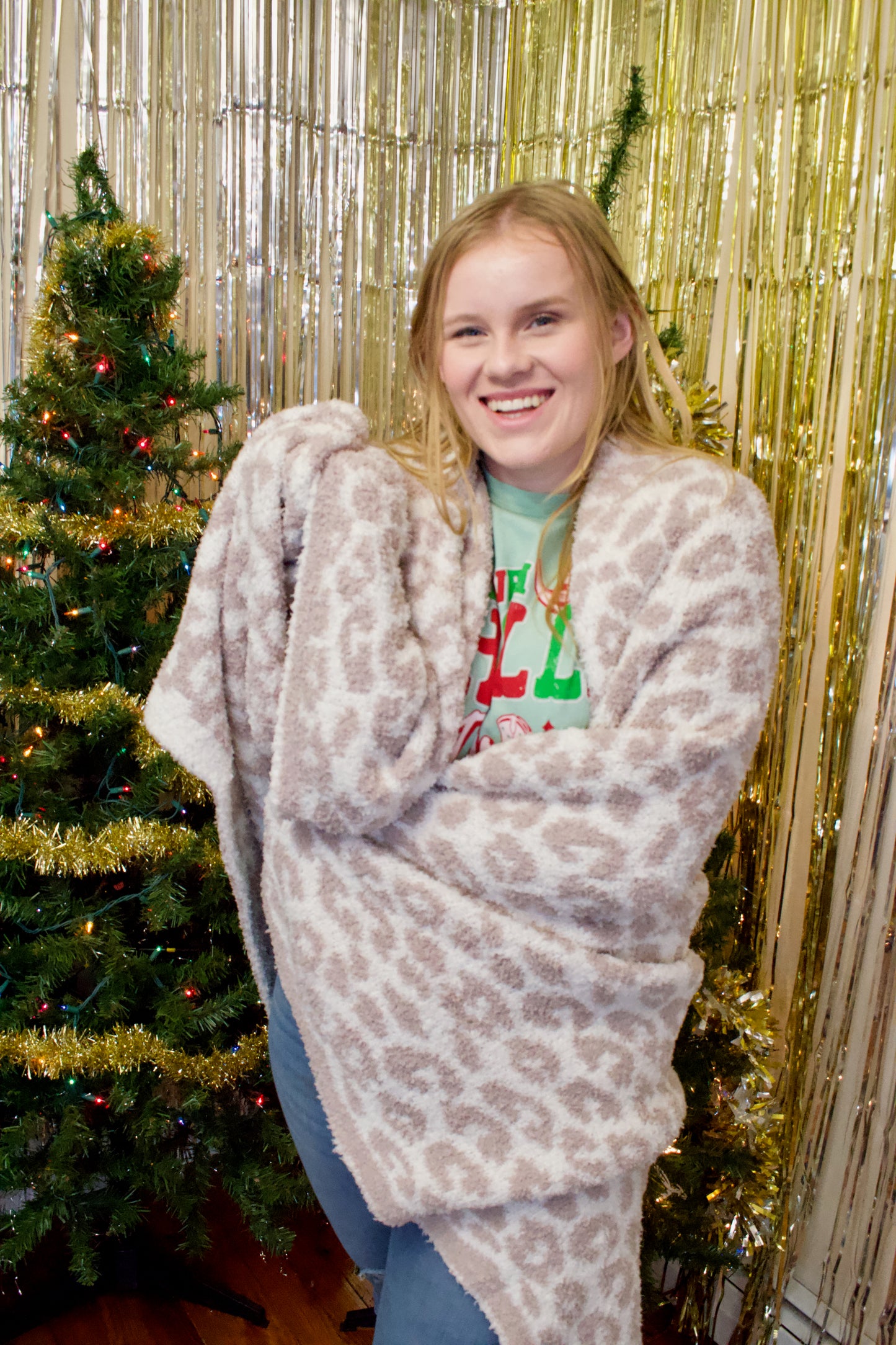 Model holding cheetah print throw blanket