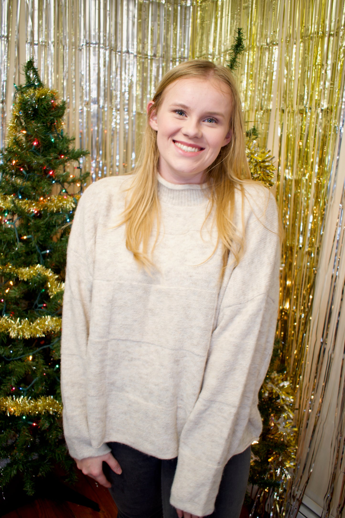 Model wearing a cream-colored sweater