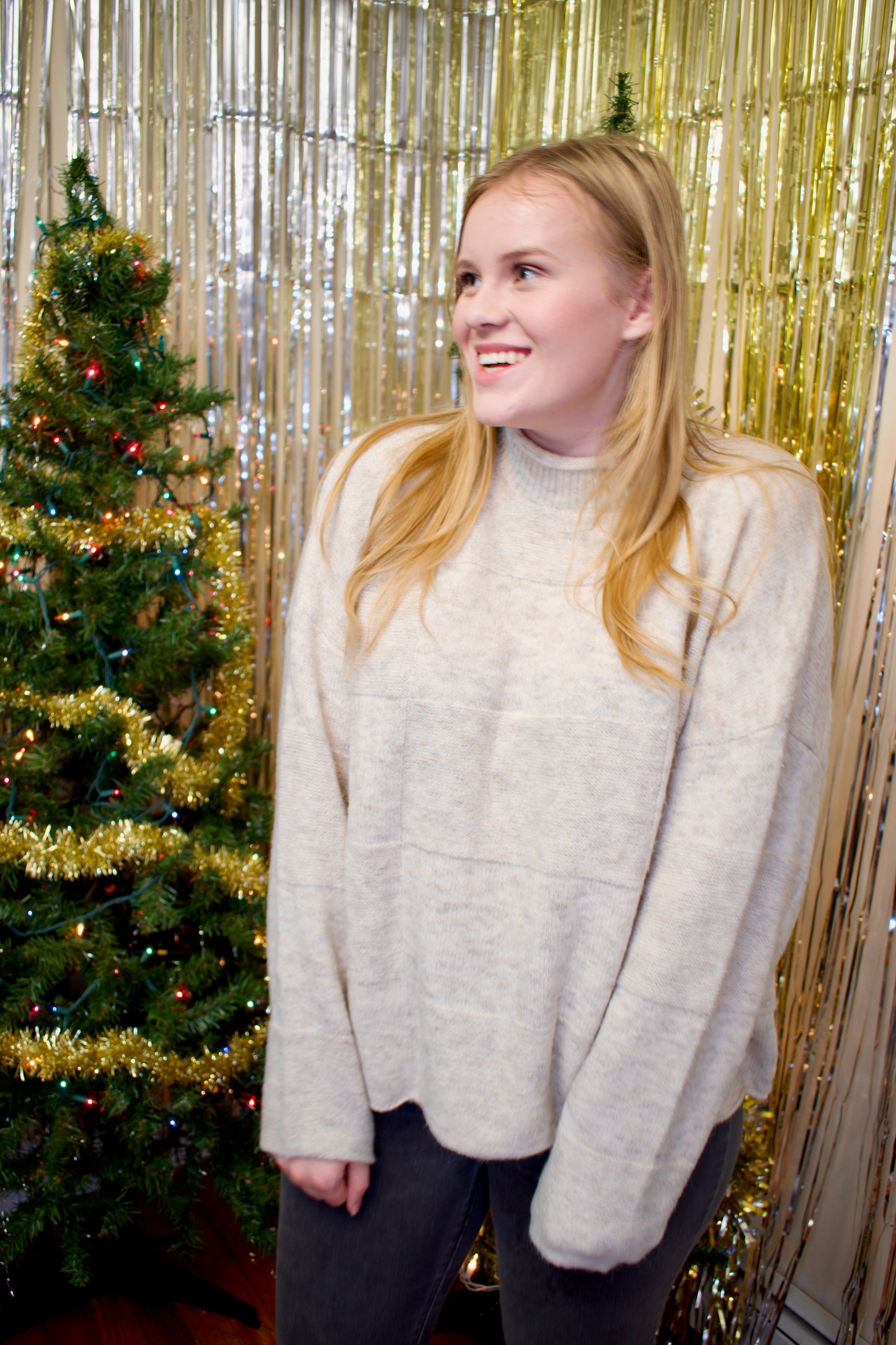 Model wearing a cream-colored sweater