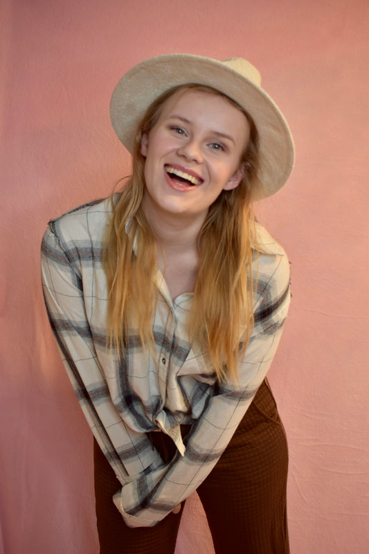 A women wearing a white and black plaid button down shirt